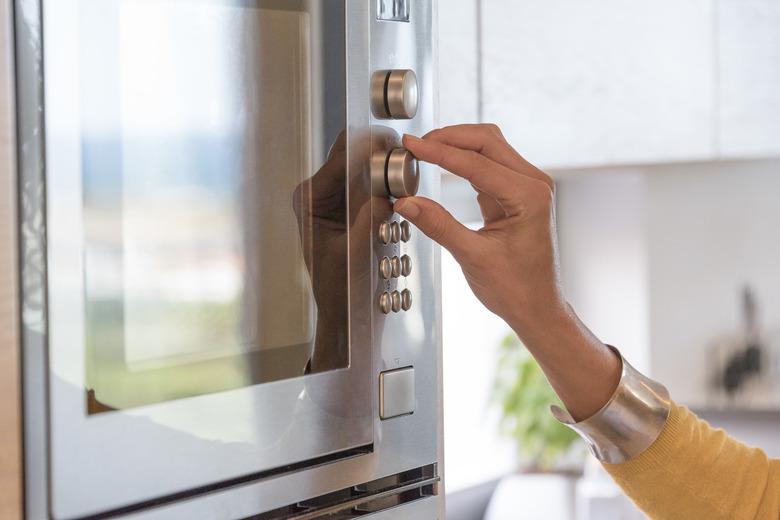 Close-up of a woman hand using an oven