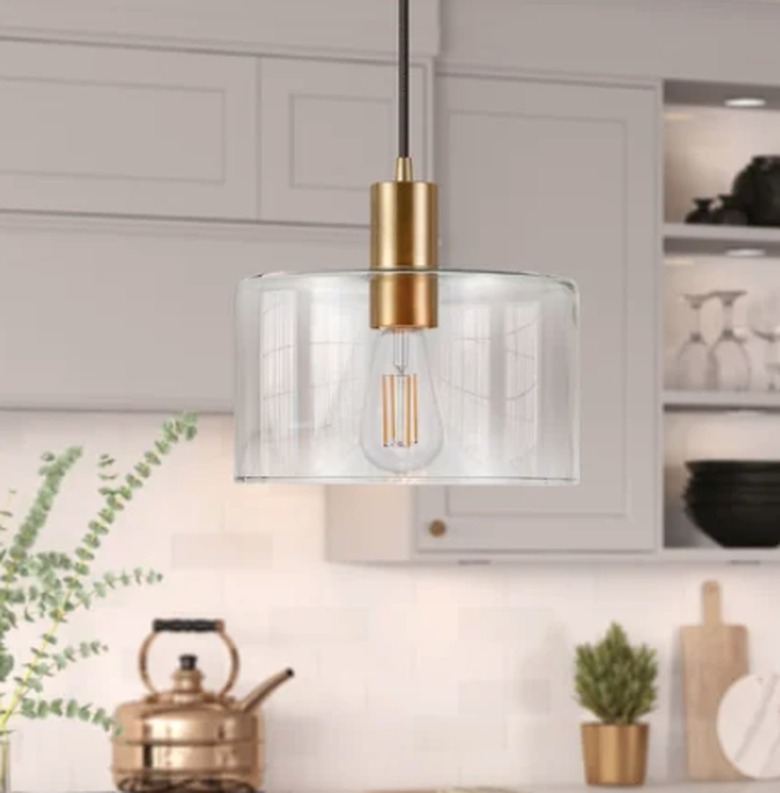 Pendant lamp with clear glass drum shade.