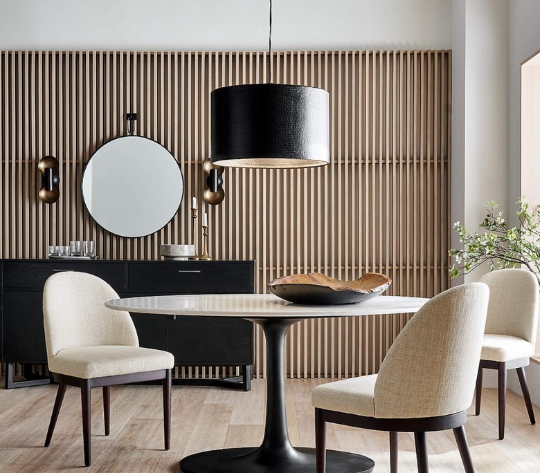 Dining area with black drum pendant.