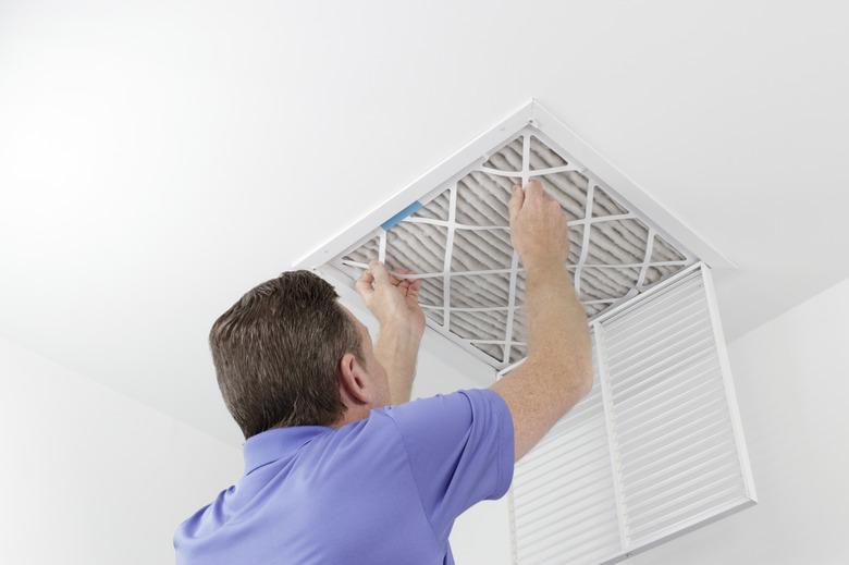 Person Removing Ceiling Air Filter