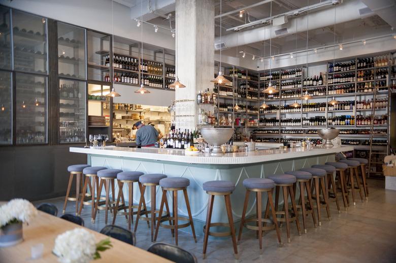 The corner bar including mid-century modern stools and silver bowls