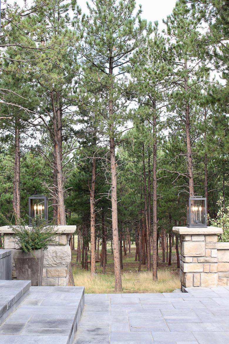 Post-style exterior house lights on top of stone posts