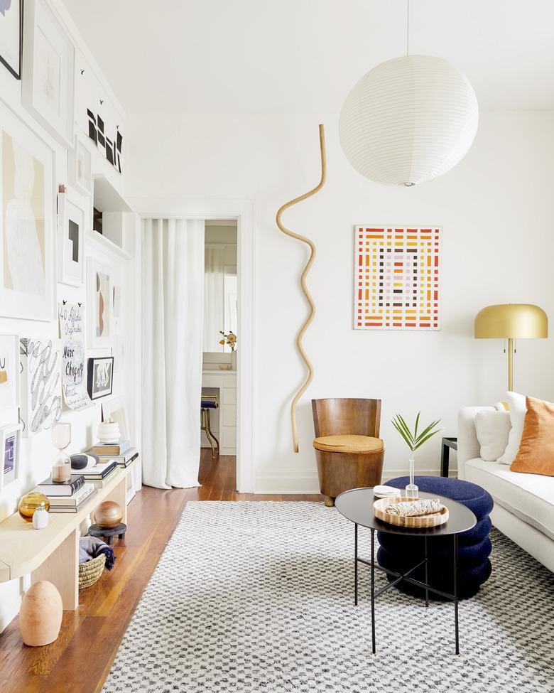 living room with lantern pendant light and brass floor lamp