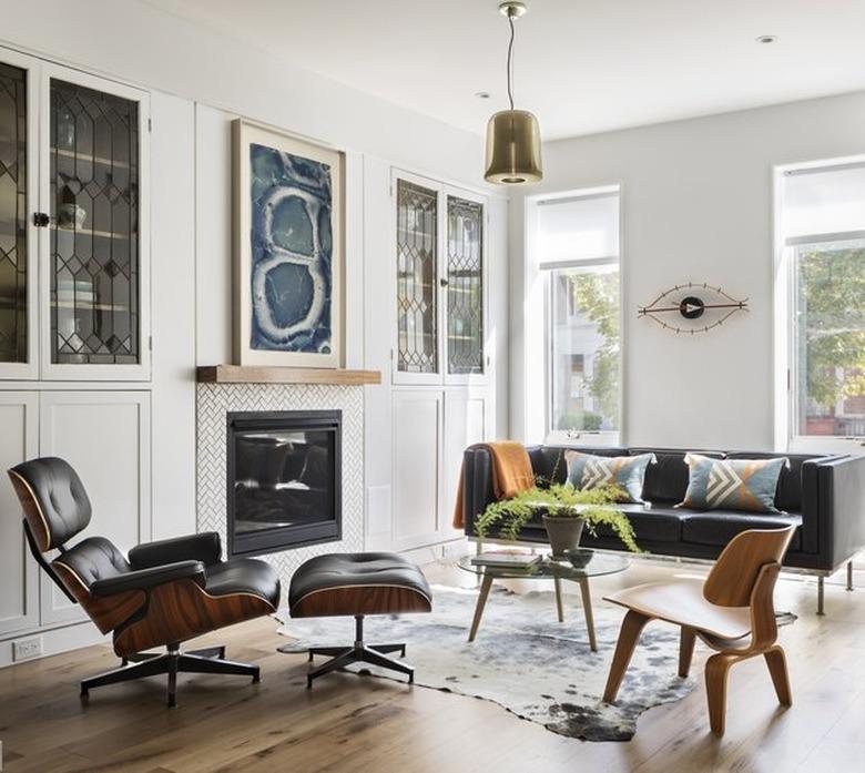 family room flooring ideas in dark walnut with midcentury chair and black couch