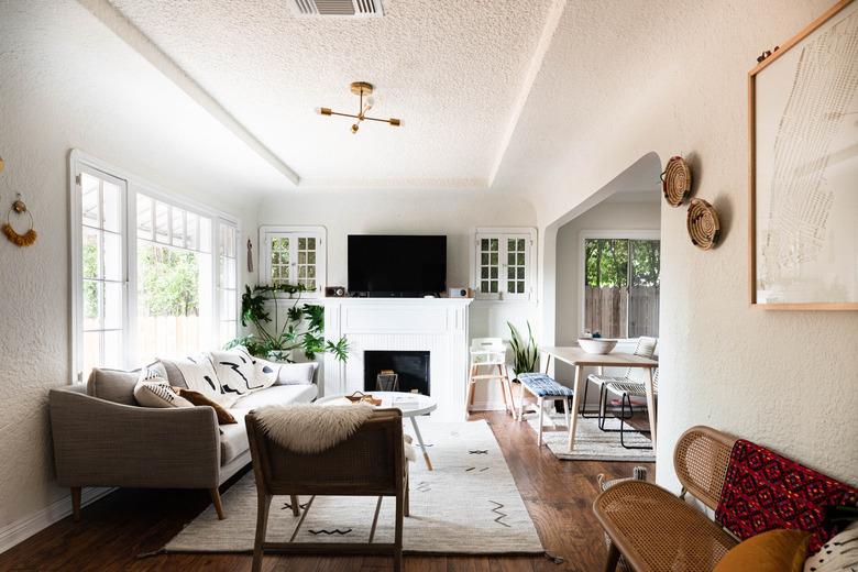 Family room with fireplace and TV layout and large windows.