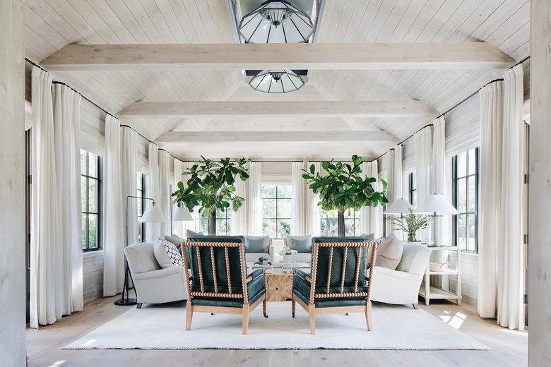 white farmhouse family room idea with wooden beams