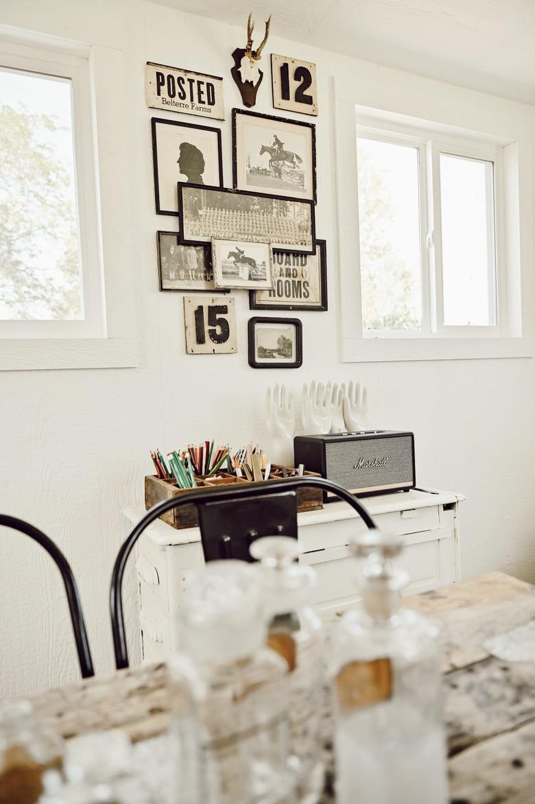 Farmhouse home office with vintage wall art and antique collections