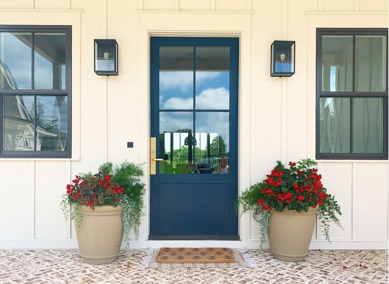 classic porch with brick flooring and board and batten walls.