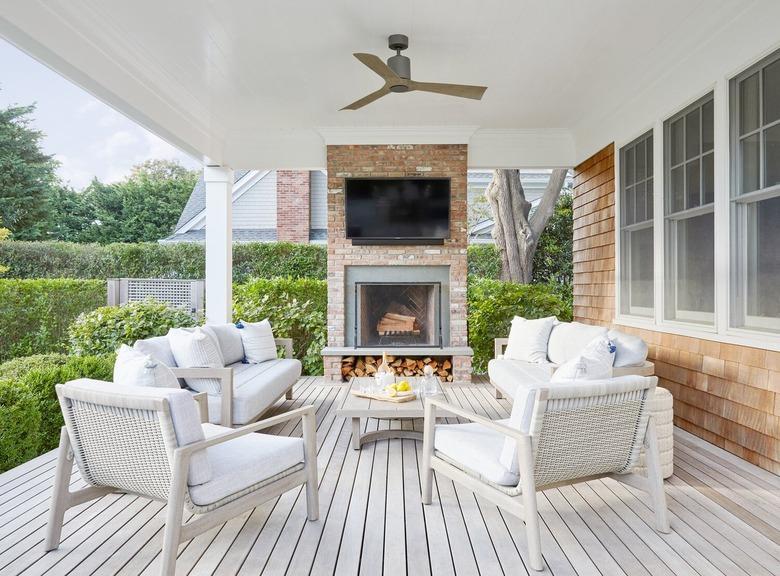 farmhouse porch with fireplace and TV