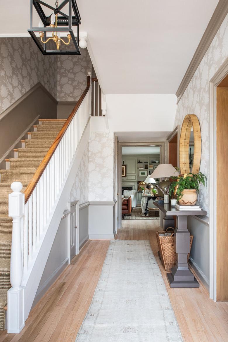 White and wood farmhouse stair railing in farmhouse entryway