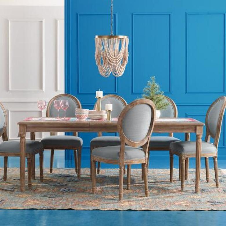 extendable shaker style farmhouse table idea with beaded chandelier and upholstered chairs