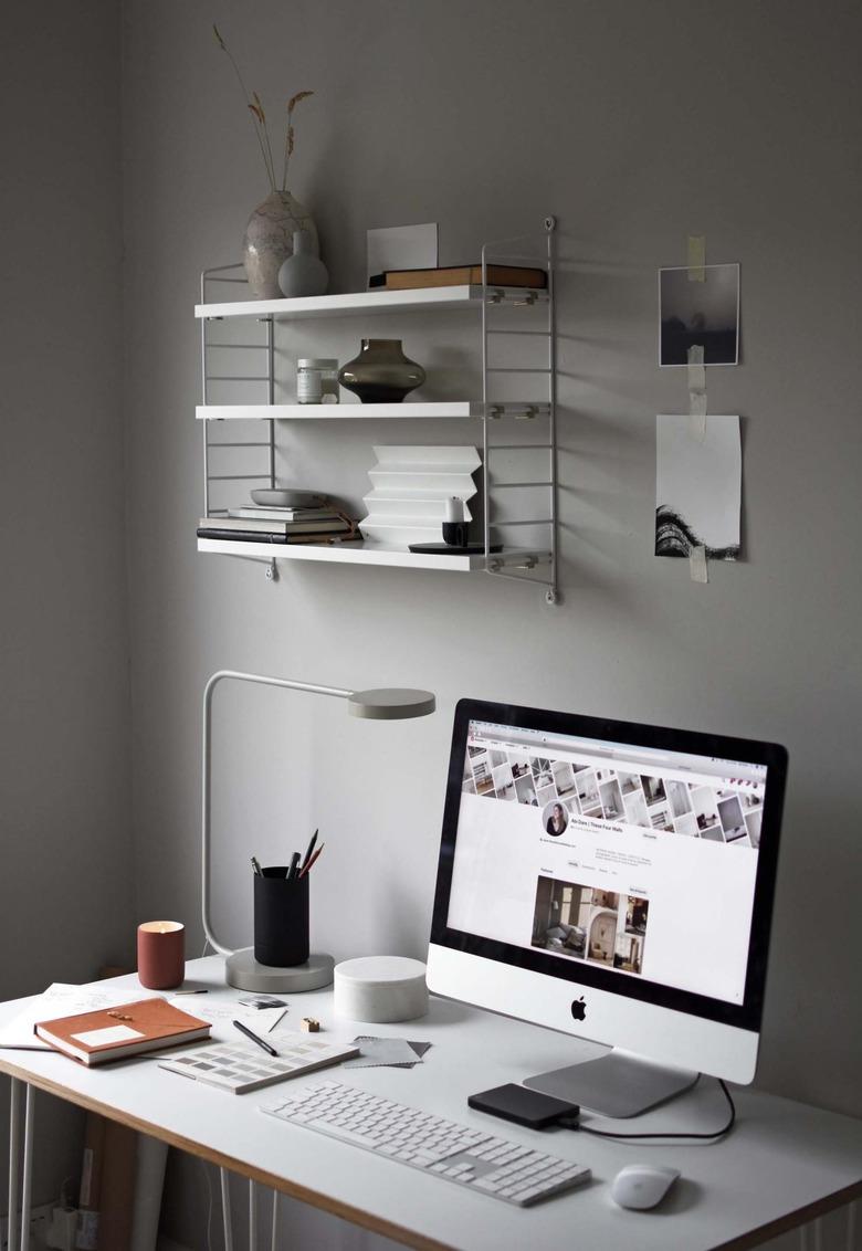 Feng Shui Home Office with light gray walls and wall shelf