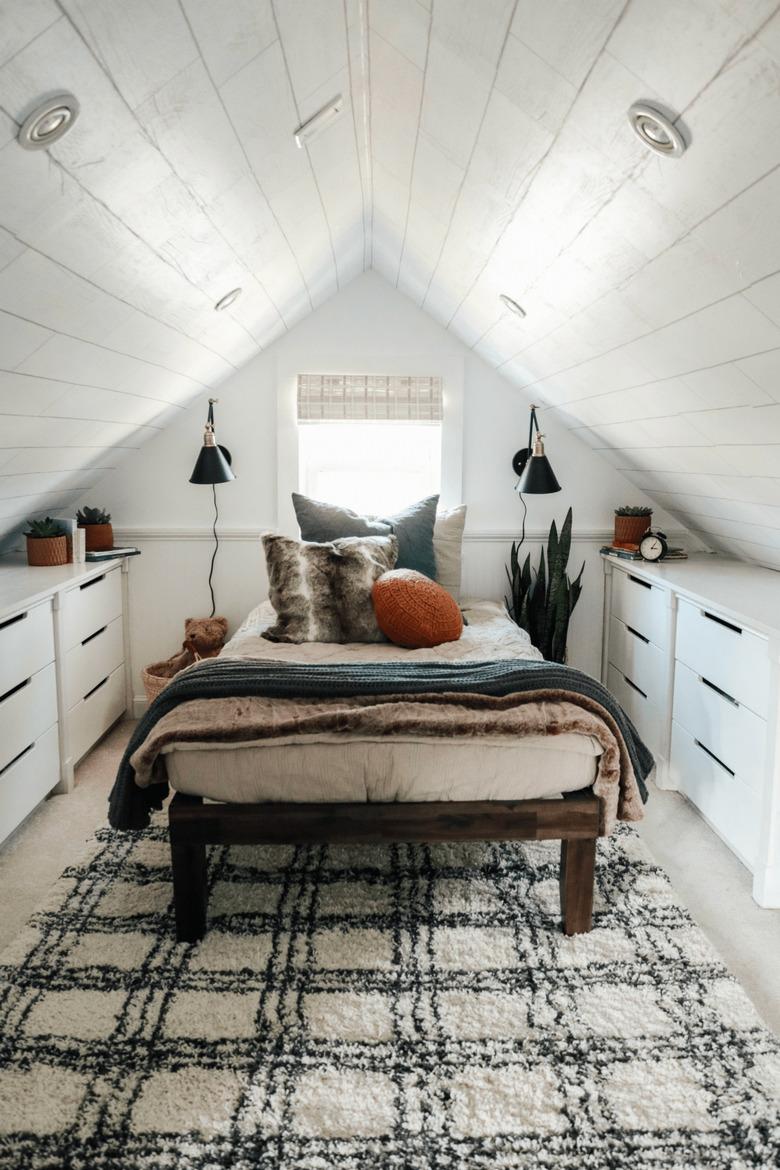 white finished attic idea for bedroom with rug and storage unites