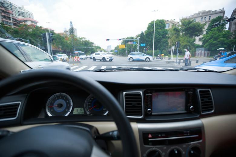 Waiting infront of the traffic light while driving car on city road