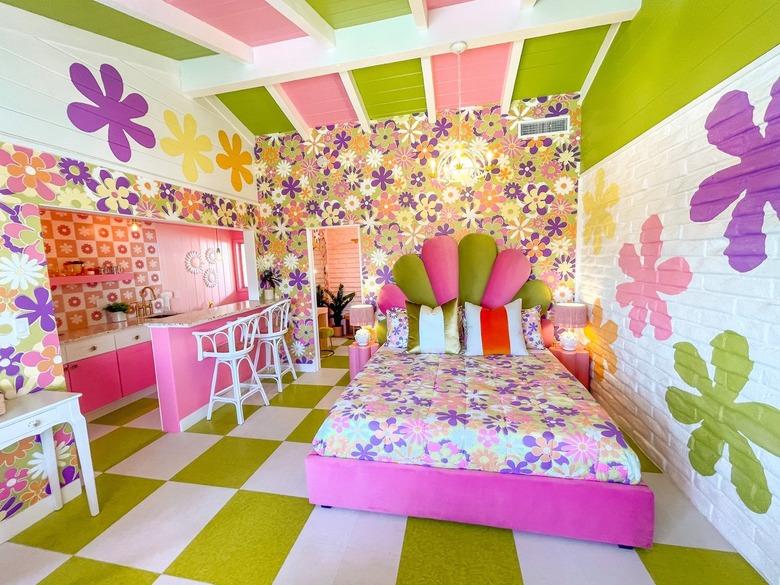 Bedroom with bright purple, pink, and green floors, ceilings, and walls.