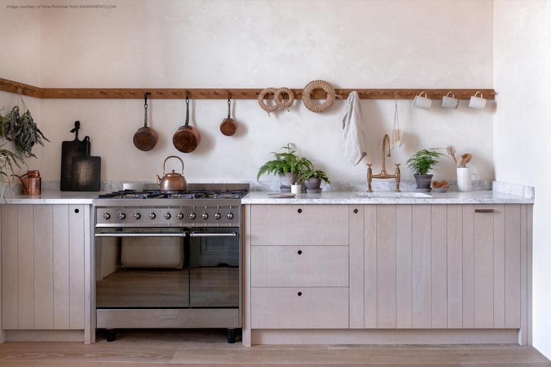 gas stovetop in natural kitchen with pan holder