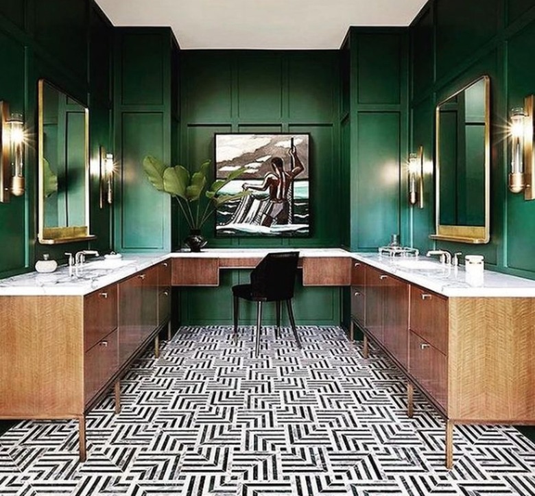 Green painted bathroom with black and white floor