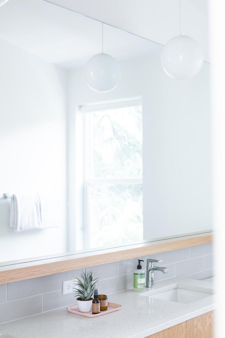 bathroom backsplash idea with gray subway tile below mirror