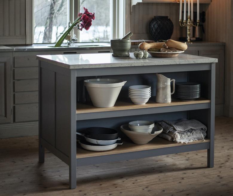 small wooden gray kitchen island with marble top and storage