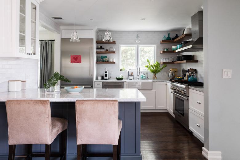 L-shaped gray kitchen island made of wood with a white quartz top