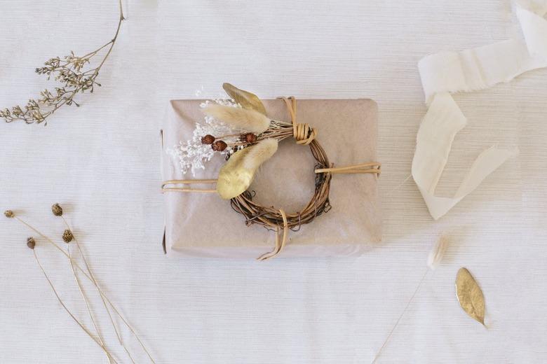 Package wrapped in neutral paper with dried plants and twigs