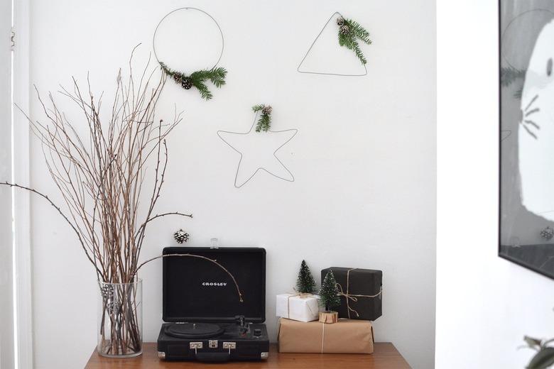 Wire, wintergreen and pinecone wreaths shaped in a circle, star, and triangle