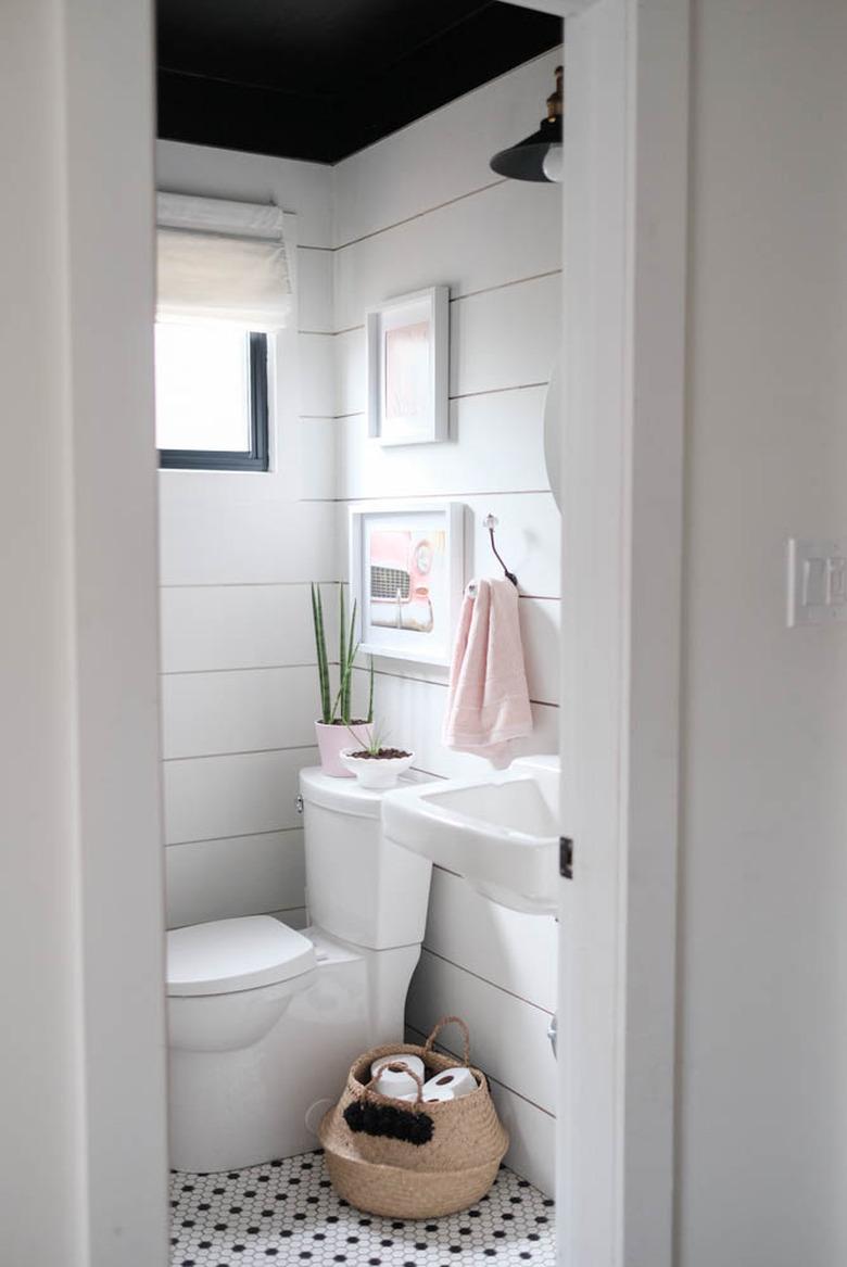 farmhouse bathroom with shiplap walls and black ceiling