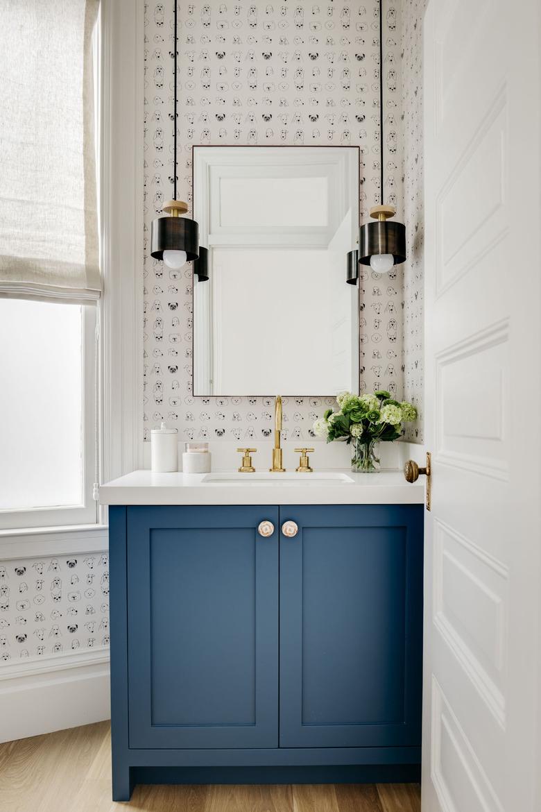 half bathroom idea with blue cabinet and pair of pendant lights