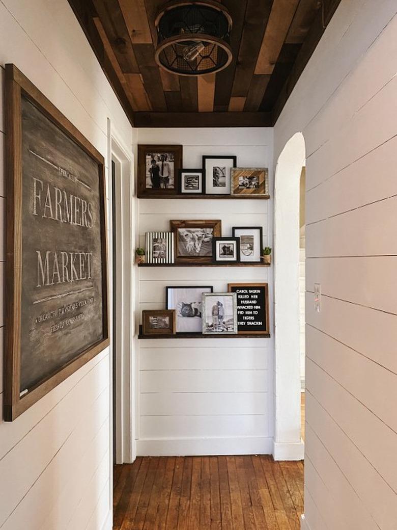 Hallway Focal Point Ideas in white paneled hallway with timber ceiling and picture ledges