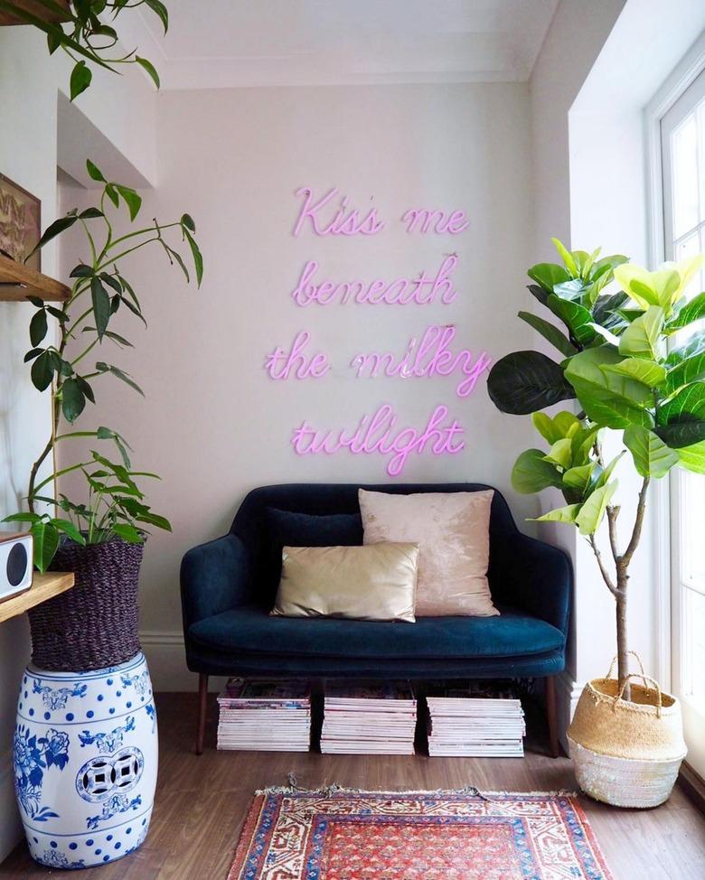 Hallway Focal Point Ideas in eclectic hallway with pink neon sign above velvet sofa