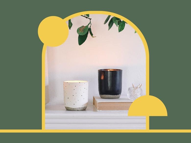 White and black candle holders on shelf