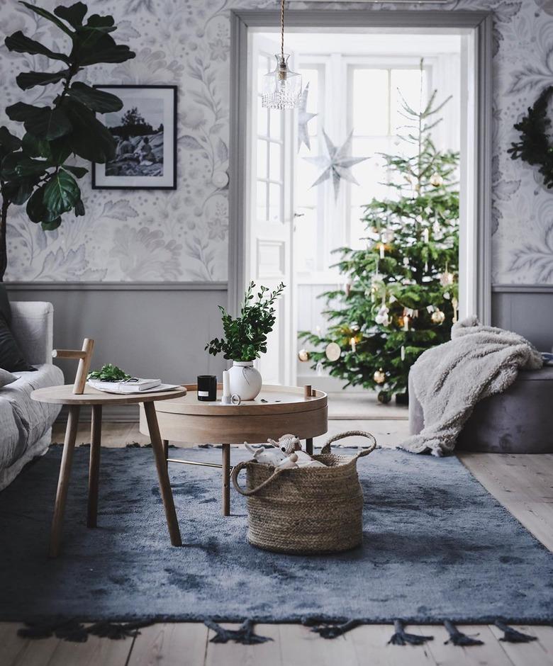 blue and gray Christmas colors in living room with christmas tree in the back