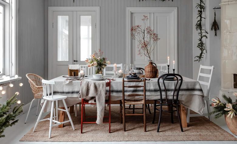 gray Christmas colors in dining room with table and holly berry and evergreen garland