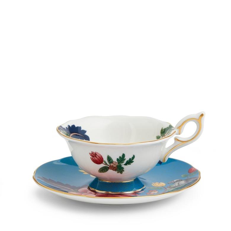 A Wedgwood Wonderlust Sapphire Garden Teacup & Saucer featuring various flowers and a monkey.