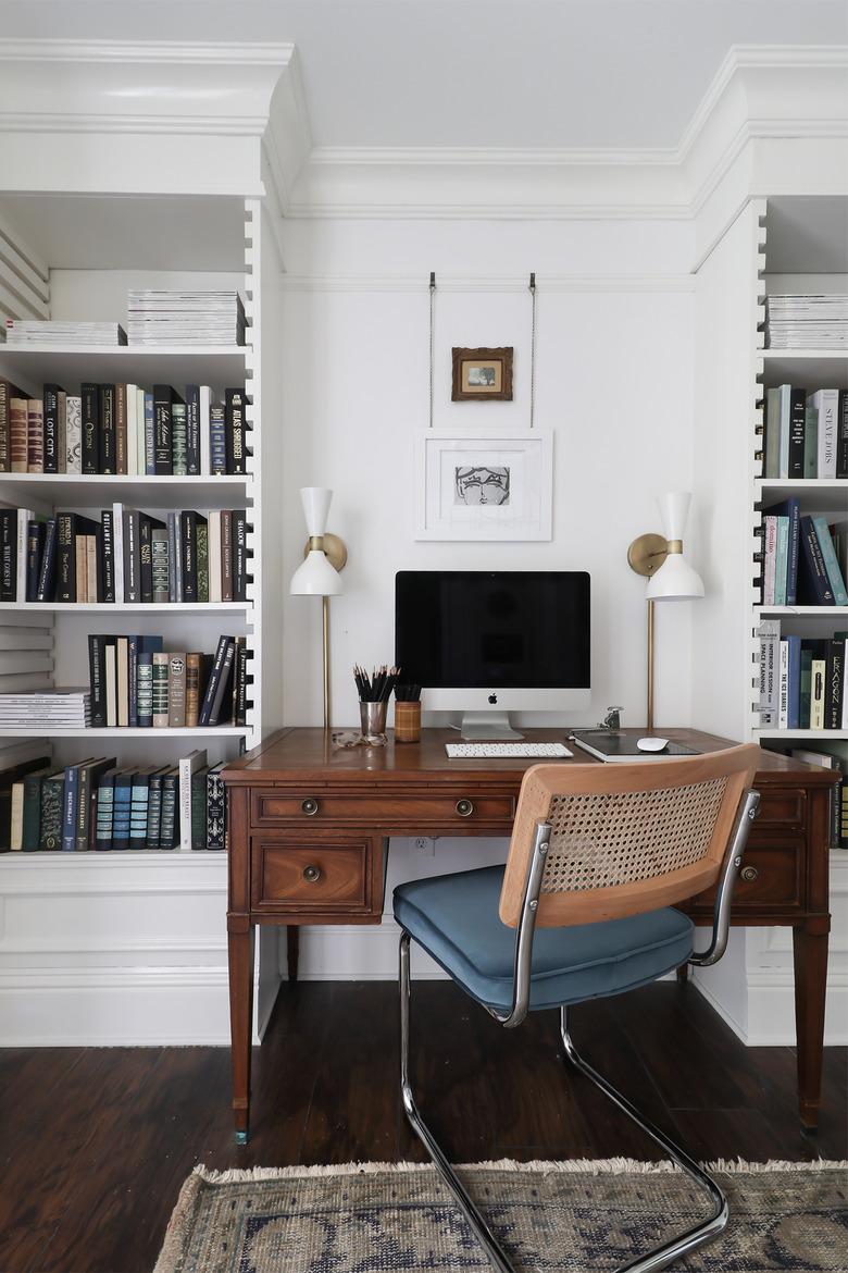 white and brass modern wall sconces in vintage inspired office