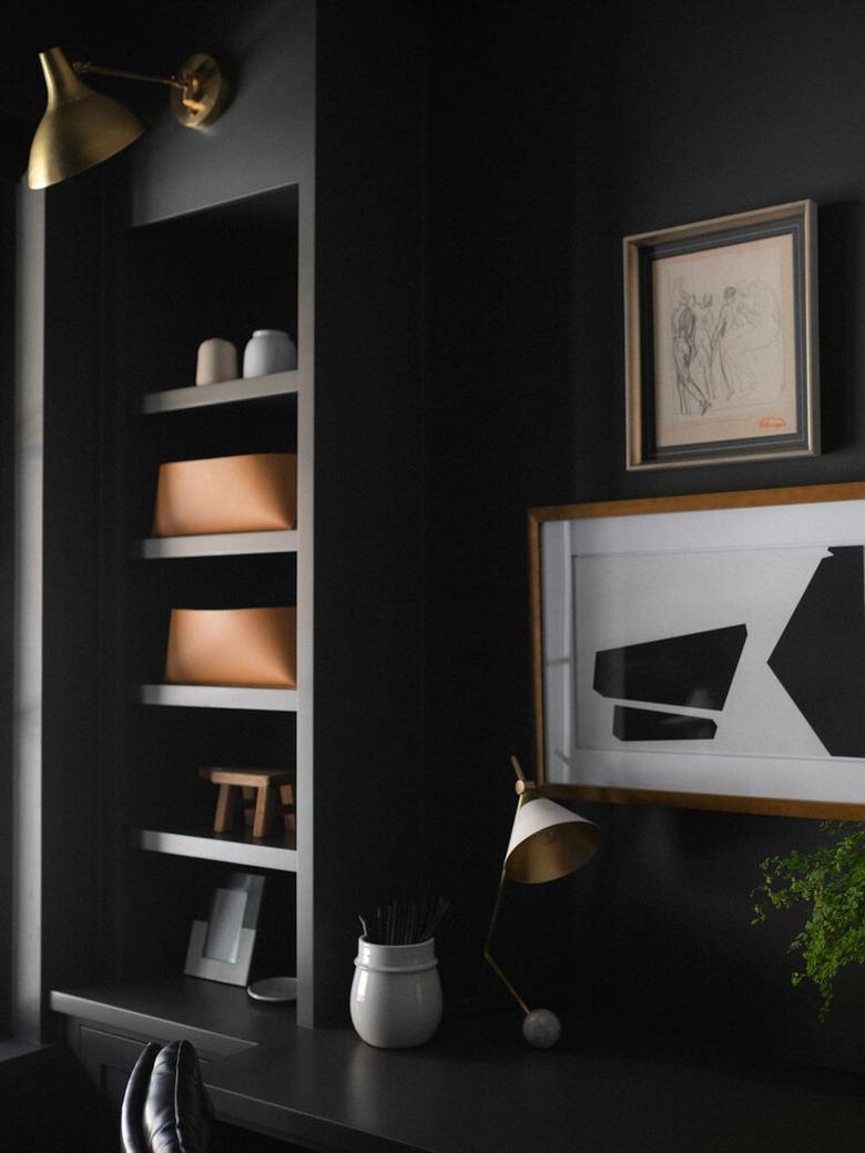 brass traditional wall sconce in modern black office