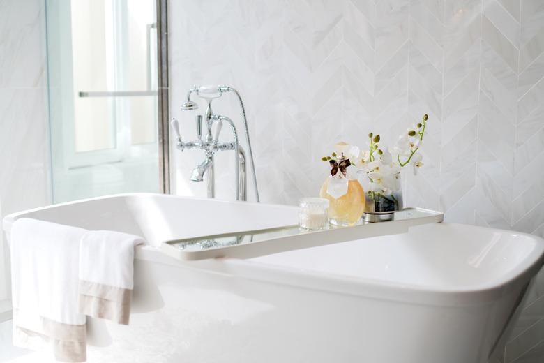 Closeup - bathtub, chrome faucet, shower interior design.