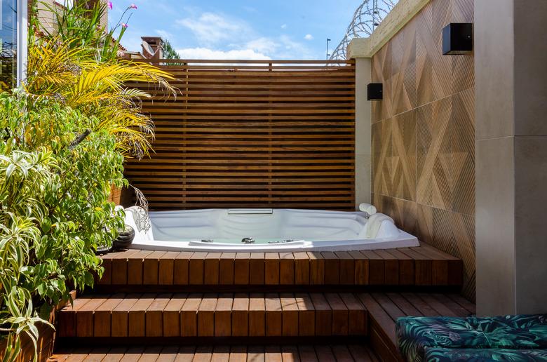 Wooden deck with hot tub.