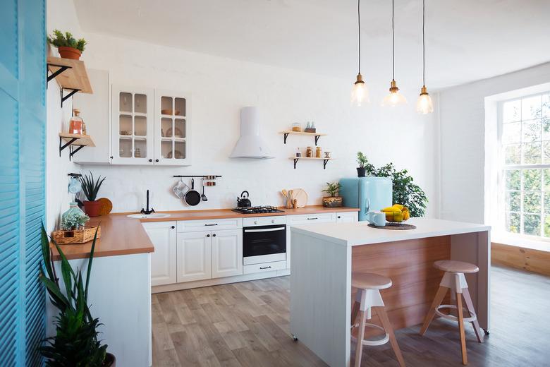 Modern Kitchen Interior with Island, Sink, Cabinets, and Big Window in New Luxury Home.