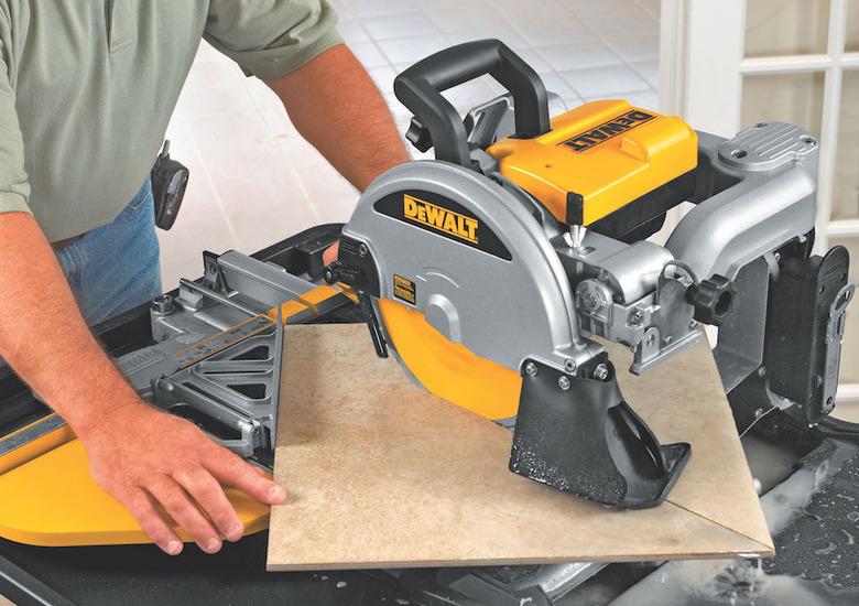 Cutting tile with a saw.