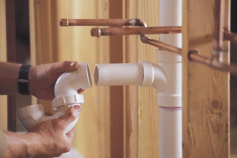 Plumber connecting PVC pipes.