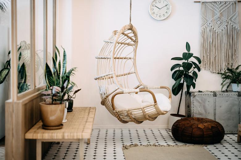 Cozy hanging chair in loft living room with stylish boho design.