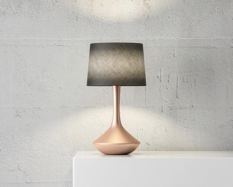 Stylish table lamp mockup with black shade and gold stand on white table