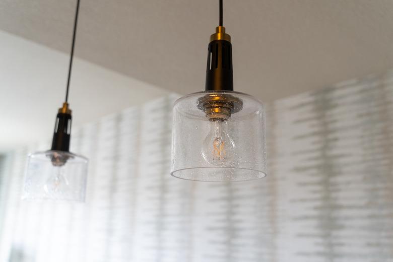 Glass light fixtures featuring exposed lightbulbs.