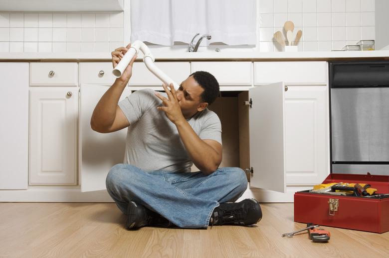 Man sitting on floor with pipe