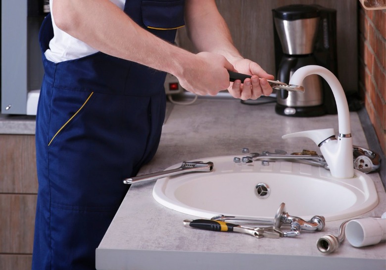 plumber fixing faucet