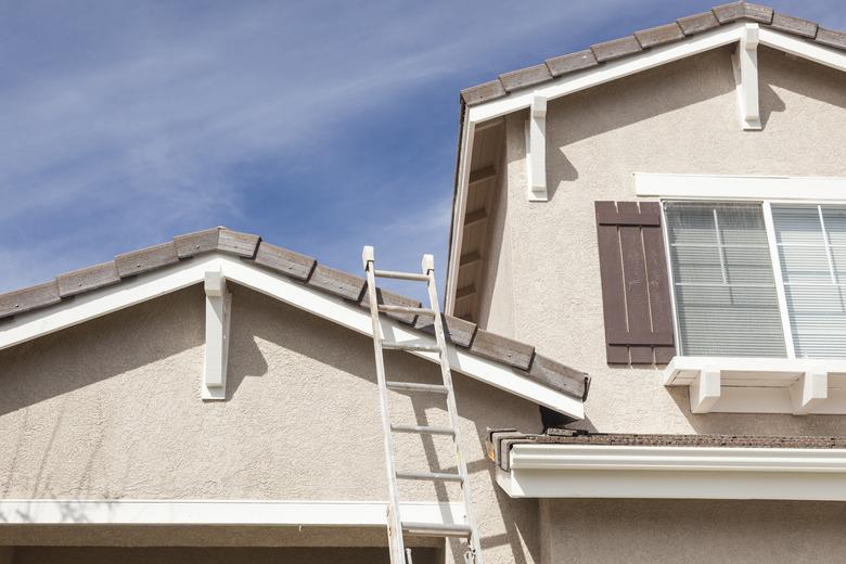 Extension Ladder Leaning Against A Freshly Painted Home