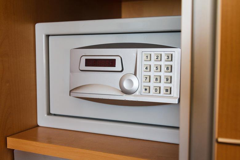 Electronic safe on shelf in cabinet