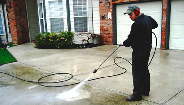 Power washing a driveway.