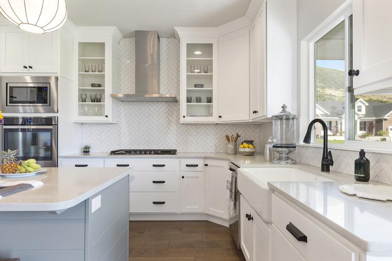 White gourmet kitchen with farmhouse sink.